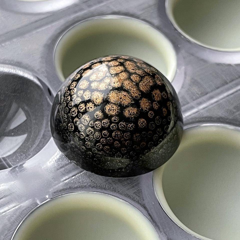 bronze dots on black
