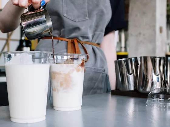 A Barista prepares milk-based drinks
