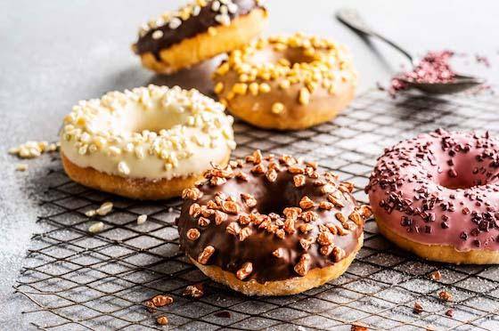 Donuts with different colored glazes and creative toppings